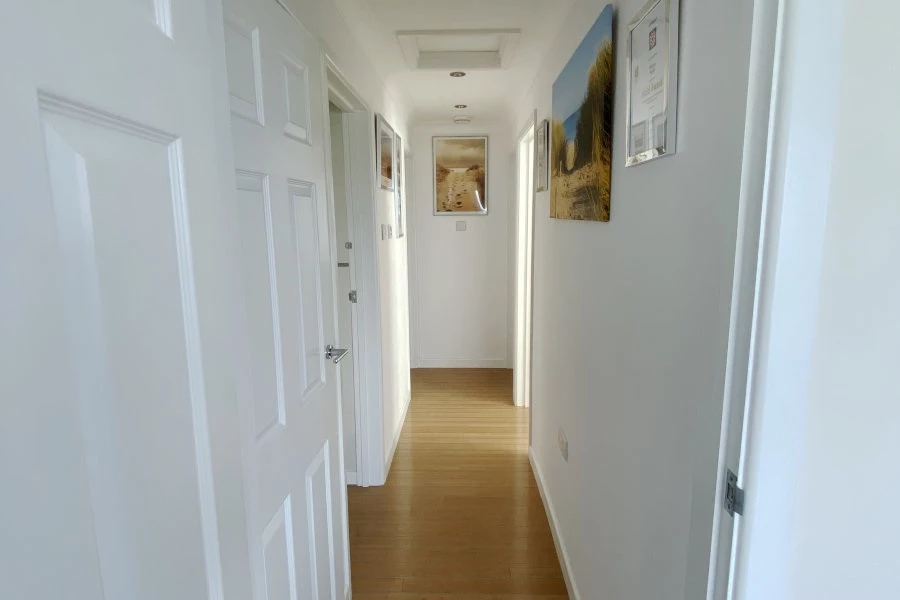 A light and airy hallway showing Hayle Beach over time